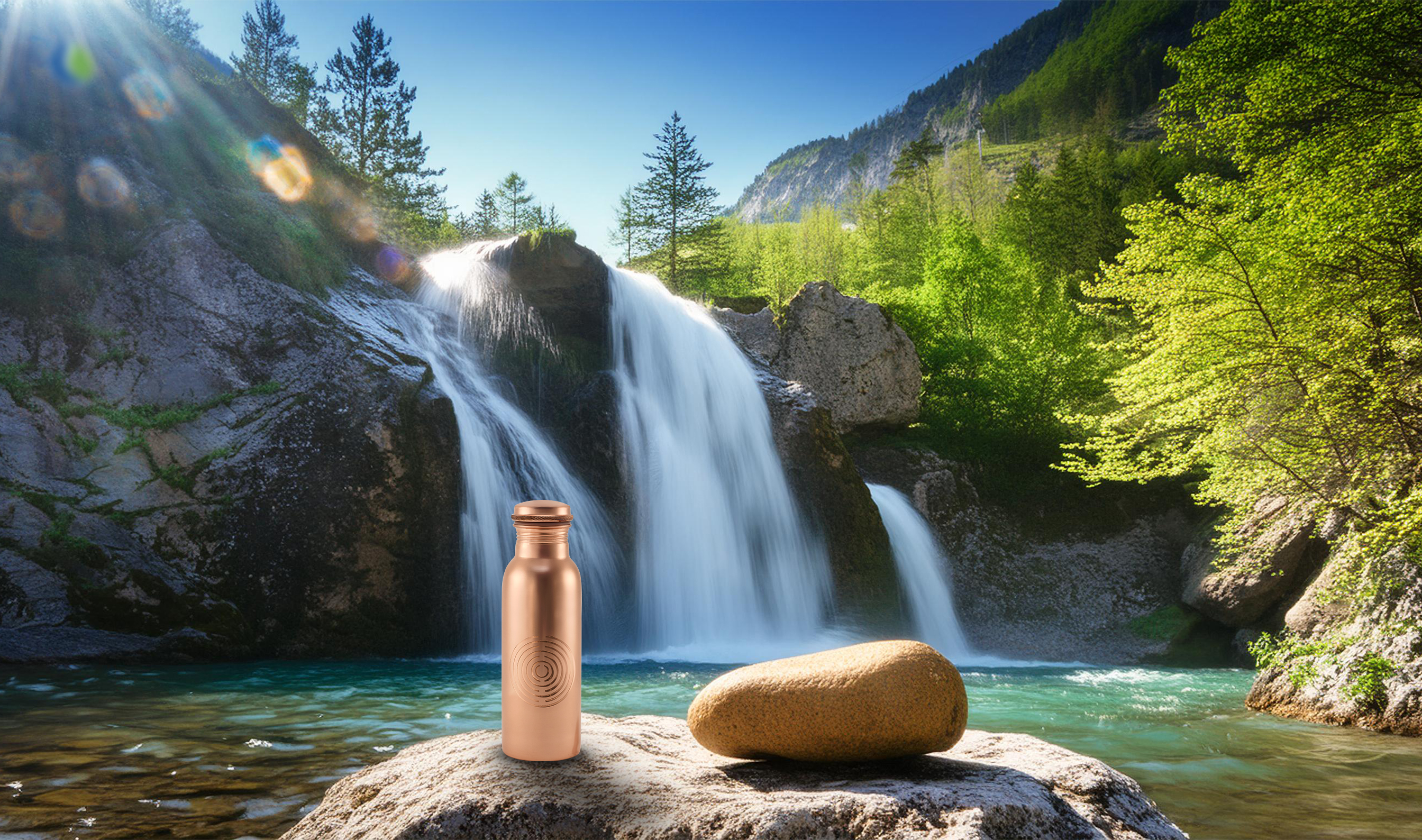 Copper water bottle on a rock near a clear blue waterfall in a lush, mountainous landscape with sunrays shining through the trees.